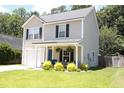 Charming two-story home with a cozy front porch and well-maintained lawn at 122 Avalon Rd, Summerville, SC 29483