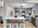 Modern kitchen featuring gray cabinets, a quartz countertop island, and stainless steel appliances at 1393 Secessionville Rd, Charleston, SC 29412