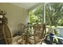 Cozy porch features a glass table and four chairs perfect for enjoying a meal or drinks outside at 1493 Little Rock Blvd, Charleston, SC 29412