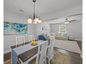 Bright dining room with modern chandelier and view into the living area, perfect for entertaining at 1514 Stanwick Dr, Johns Island, SC 29455