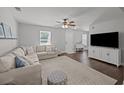 Bright living room featuring a comfy sectional, ceiling fan, and large windows for natural light at 1514 Stanwick Dr, Johns Island, SC 29455