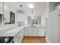 White kitchen featuring modern appliances and finishes, with an open view to an adjacent room at 1530 Fort Johnson Rd # 2E, Charleston, SC 29412