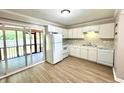 Kitchen with white appliances, cabinets, countertop, and sliding door to outdoor patio at 1820 Mepkin Rd # 1019, Charleston, SC 29407
