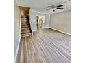 An open living room features laminate flooring, staircase, and ceiling fan at 1820 Mepkin Rd # 1019, Charleston, SC 29407