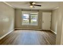 A well-lit living room with laminate flooring, a large window, and neutral paint at 1820 Mepkin Rd # 1019, Charleston, SC 29407
