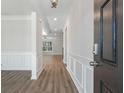 Welcoming entryway with wood flooring, wainscoting, and an open view into the home's interior spaces at 206 Palfrey Dr, Ridgeville, SC 29472