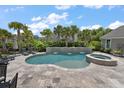Stunning pool and hot tub combination with lush landscaping and elegant stone accents at 2879 River Vista Way, Mount Pleasant, SC 29466