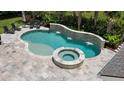 Inviting backyard pool and spa area with a decorative stone waterfall feature at 2879 River Vista Way, Mount Pleasant, SC 29466