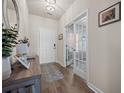 Welcoming entryway with wood flooring, decorative rug, and French doors to the office at 291 Lucca Dr, Summerville, SC 29486