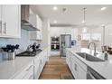 Modern kitchen with white cabinets, stainless steel appliances, and hardwood floors at 291 Lucca Dr, Summerville, SC 29486