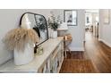 Stylish entryway features a console table with decorative accents and hardwood floors at 3082 Emma Ln, Mount Pleasant, SC 29466