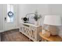 Bright foyer with decorated table, mirror, and decor with hard wood flooring at 3082 Emma Ln, Mount Pleasant, SC 29466