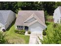 Aerial view of a home boasting a well-manicured lawn and a two-car garage, set in a peaceful neighborhood at 3198 Conservancy Ln, Charleston, SC 29414