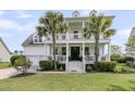 Inviting two-story home featuring a spacious front porch, elegant columns, and lush landscaping at 3224 Hatchway Dr, Mount Pleasant, SC 29466