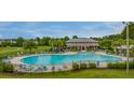 Large community pool with lounge chairs and tables for relaxation at 339 Iveson Rd, Summerville, SC 29486