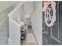 Welcoming foyer with hardwood floors, staircase, and stylish decor leading into the home at 352 Matuskovic Dr, Charleston, SC 29414