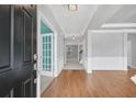 Bright foyer showcasing wood floors, decorative trim, and a view into adjacent rooms at 354 Beachgrass Ln, Summerville, SC 29486