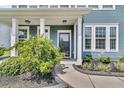 Charming front porch with classic white columns and well-maintained landscaping at 354 Beachgrass Ln, Summerville, SC 29486