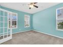 Well-lit office space with neutral carpet, ceiling fan, and ample natural light at 354 Beachgrass Ln, Summerville, SC 29486