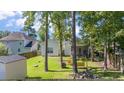 Green backyard with mature trees and a shed at 404 Norwood Ct, Moncks Corner, SC 29461