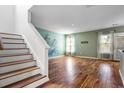Inviting living room featuring hardwood floors, stairs, and an unique wall design at 412 Beverly Dr, Summerville, SC 29485