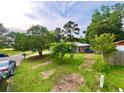 Expansive front yard featuring lush green grass and mature trees, creating a private and serene setting at 4470 Farmwood Ct, Ladson, SC 29456