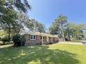 Charming brick home with well-maintained lawn and mature trees at 449 Estates Dr, Walterboro, SC 29488