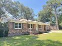 Charming brick home with well-maintained lawn and covered front porch at 449 Estates Dr, Walterboro, SC 29488