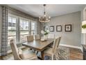 Bright dining room featuring hardwood floors, natural light, and elegant chandelier at 464 White Magnolia St, Moncks Corner, SC 29461