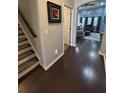 Inviting entryway with hardwood floors, stairs with carpet runner, and a glimpse into the open living space at 5008 W W Liberty Meadows Dr, Summerville, SC 29485
