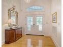 Elegant foyer features gleaming hardwood floors, a decorative mirror, and stylish chandelier at 5084 Timber Race Crse, Hollywood, SC 29449
