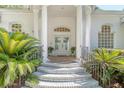 Grand front entrance with stately columns, beautiful double doors, and manicured landscaping at 5084 Timber Race Crse, Hollywood, SC 29449