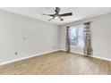 Bright, airy bedroom with wood floors, ceiling fan, and a large window at 703 Temple Rd # A, Ladson, SC 29456