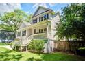 Charming two-story home featuring a welcoming front porch and lush landscaping at 914 Dill Ave, Charleston, SC 29412