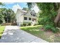 Beautiful two-story home with a quaint front porch, complemented by a lush green yard and driveway at 914 Dill Ave, Charleston, SC 29412