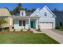 Inviting light blue home with a well-kept lawn and landscaping, featuring a two-car garage at 1009 Field Sparrow Dr # Cc3-2-6, Ravenel, SC 29470