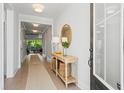 Bright foyer featuring hardwood floors, decorative table, and views into the living space at 105 Philips Park St, Summerville, SC 29486