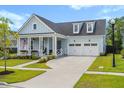 Beautiful light blue two-story home with a two-car garage and well-manicured lawn at 105 Philips Park St, Summerville, SC 29486