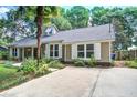 View of home's exterior featuring well-maintained lawn, driveway, and traditional siding at 1052 Yorktown Dr, Charleston, SC 29412