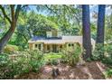 View of home's exterior, showing manicured lawn and mature trees providing shade and privacy at 1052 Yorktown Dr, Charleston, SC 29412
