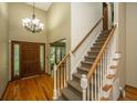 Inviting foyer with hardwood floors, staircase, and chandelier at 107 Joes Ln, Summerville, SC 29486