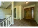 Welcoming front porch featuring a wood floor and paneled door with sidelights at 107 Joes Ln, Summerville, SC 29486