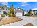 Inviting one-story home with gray siding, attached garage, and well-maintained landscaping at 112 Riviera Dr, Summerville, SC 29483