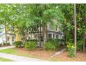 Charming two-story townhouse with a covered front porch, complemented by lush landscaping at 114 Grand Palm Ln, Summerville, SC 29485