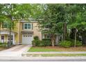 Charming two-story townhouse with an attached garage and well-manicured front yard at 114 Grand Palm Ln, Summerville, SC 29485
