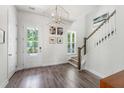Bright foyer featuring hardwood floors, staircase, modern lighting, and access to the outside at 120 E Respite Ln, Summerville, SC 29483