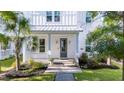 Inviting front entrance with a quaint porch, palm tree, and manicured garden at 120 E Respite Ln, Summerville, SC 29483