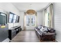 Comfortable living room with leather sofa, large windows, and stylish decor at 120 E Respite Ln, Summerville, SC 29483