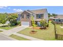 A corner lot home with a two-car garage, brick facade, and well-maintained lawn at 1302 Paint Horse Ct, Mount Pleasant, SC 29429