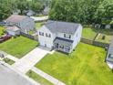 Aerial view of a home showing the spacious lawn, two car garage, and proximity to neighborhood amenities at 1350 Pinyon Pine Dr, Ladson, SC 29456